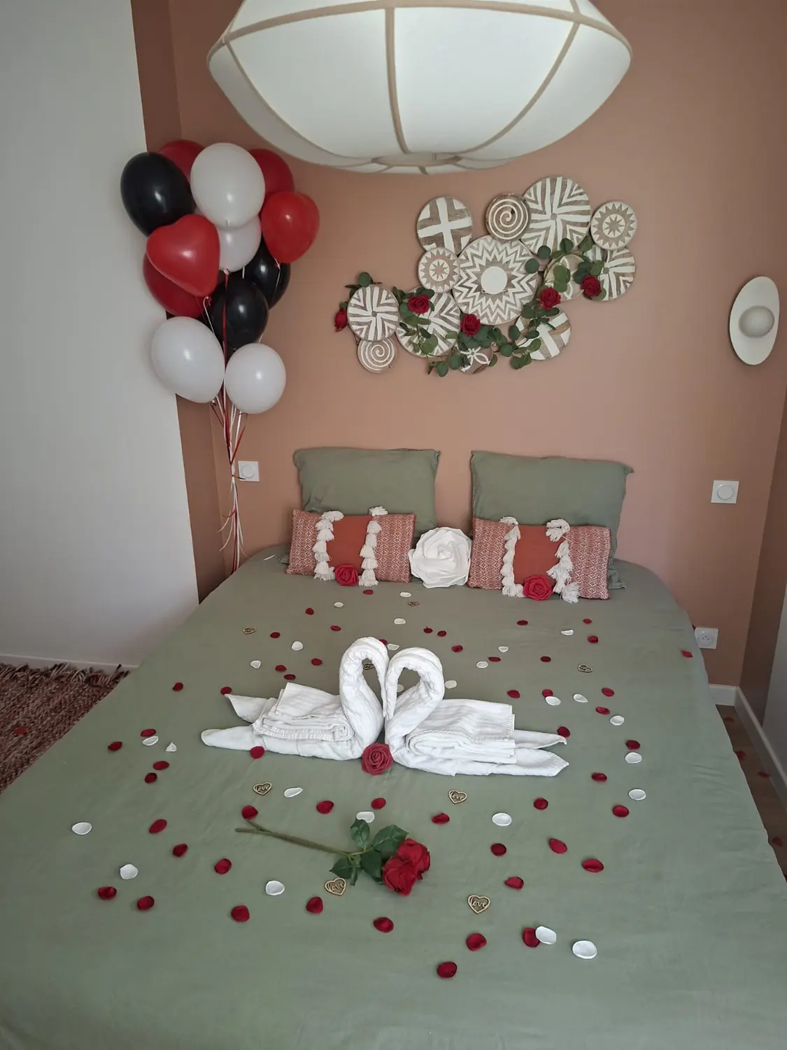 Lit décoré de pétales de roses et de cygnes de serviettes, vu de dessus